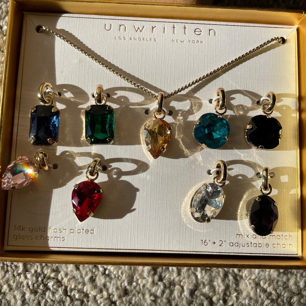 Unwritten (Macys)  Boxed set of chain with 9 different glass pendants
